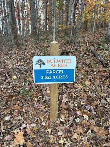 a sign that is sitting on a rock