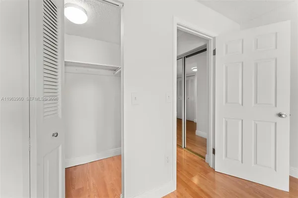 a view of a hallway with wooden floor