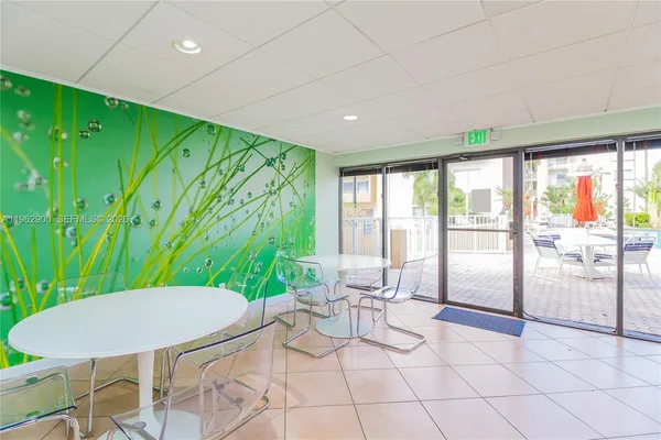 a room with pool table and windows