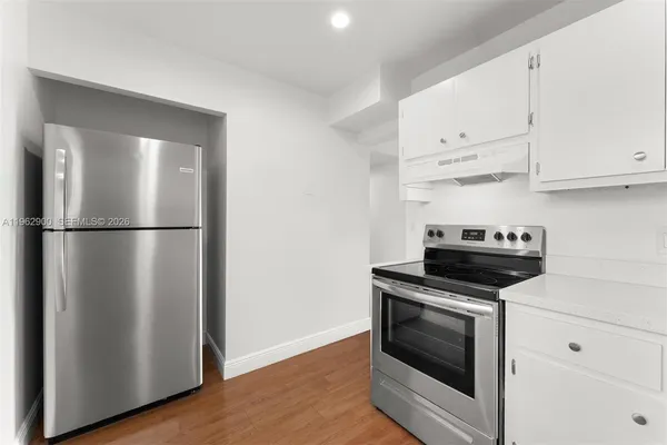a kitchen with cabinets and steel stainless steel appliances