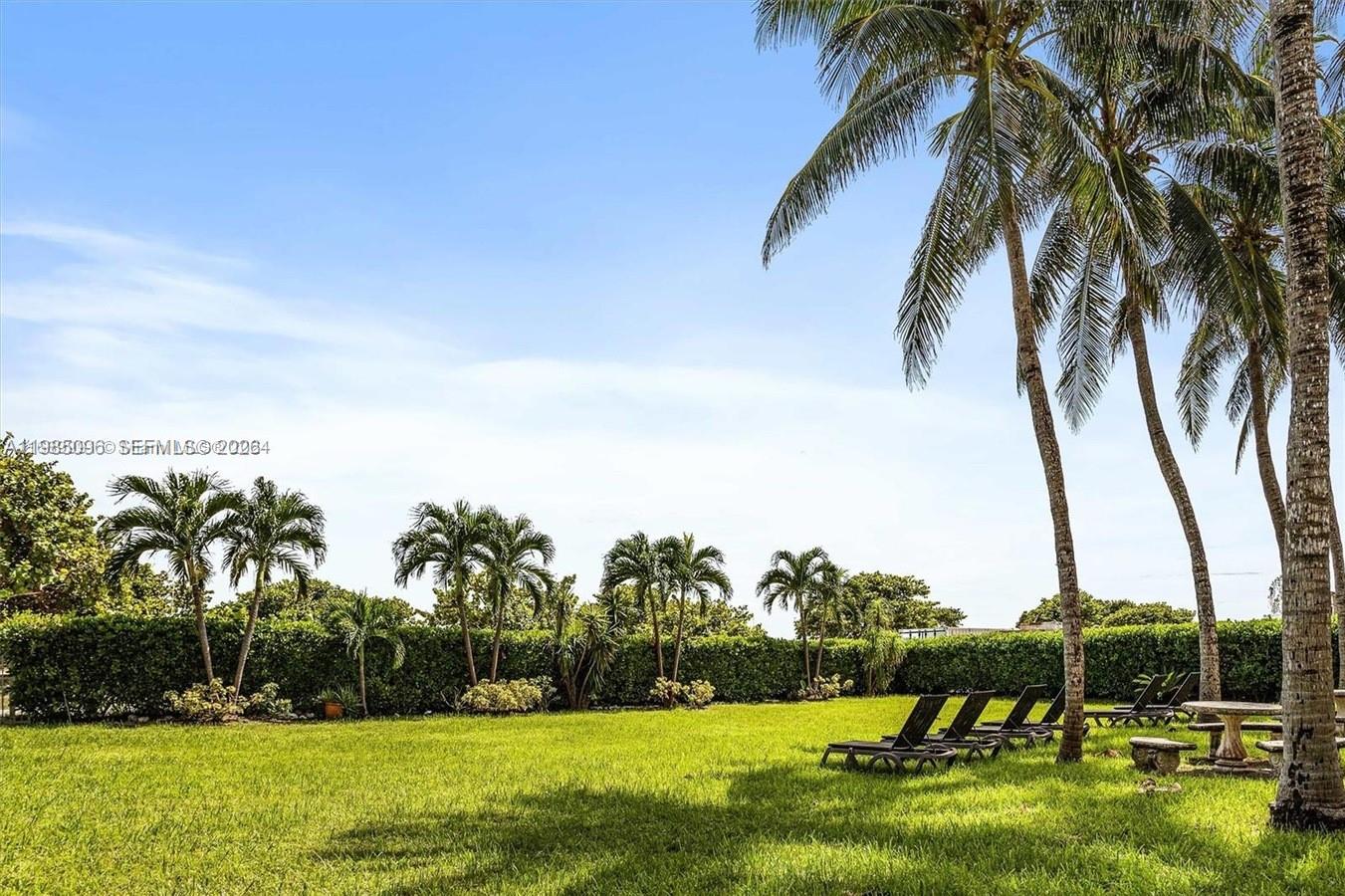 9195 Collins Avenue, Unit PH4 Surfside, FL 33154 - Photo 17 of 22 a view of yard with swimming pool and green space