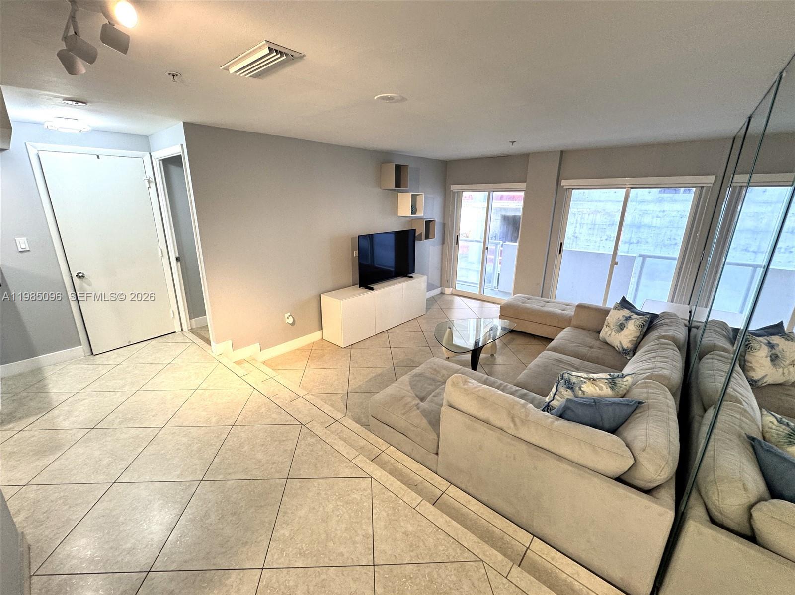 9195 Collins Avenue, Unit PH4 Surfside, FL 33154 - Photo 2 of 22 a large bedroom with a bed and window