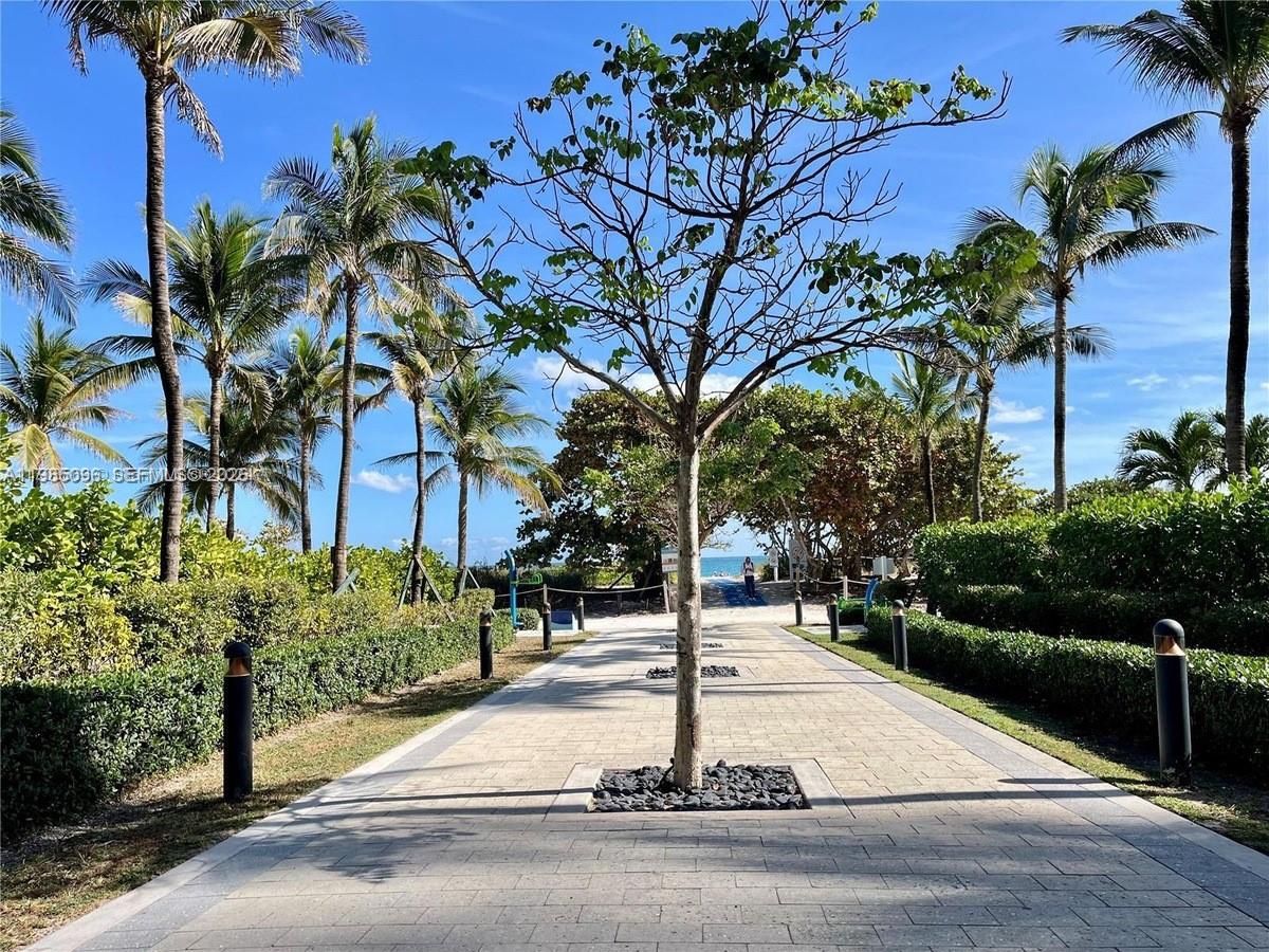 9195 Collins Avenue, Unit PH4 Surfside, FL 33154 - Photo 21 of 22 a street sign on a sidewalk next to a road