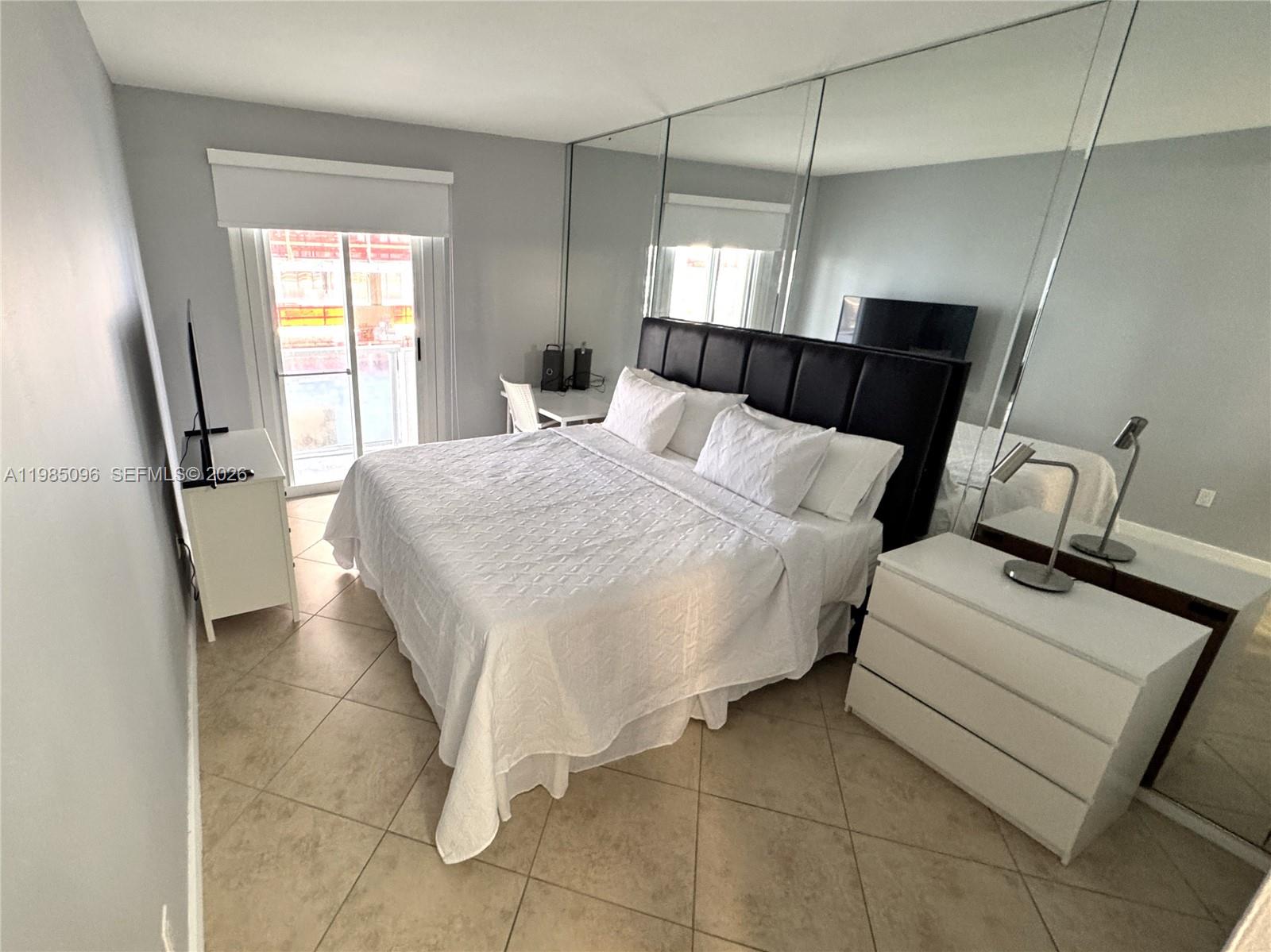 9195 Collins Avenue, Unit PH4 Surfside, FL 33154 - Photo 7 of 22 a bedroom with a bed and window
