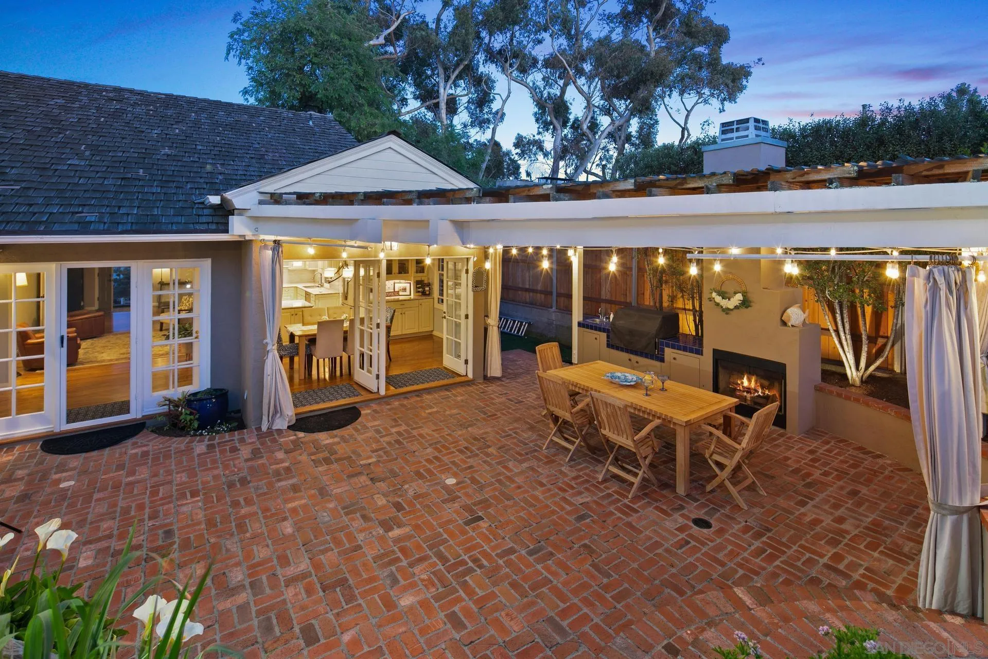 3733 La Cresta Drive San Diego, CA 92107 - Photo 2 of 57 a view of a patio with table and chairs under an umbrella with large trees