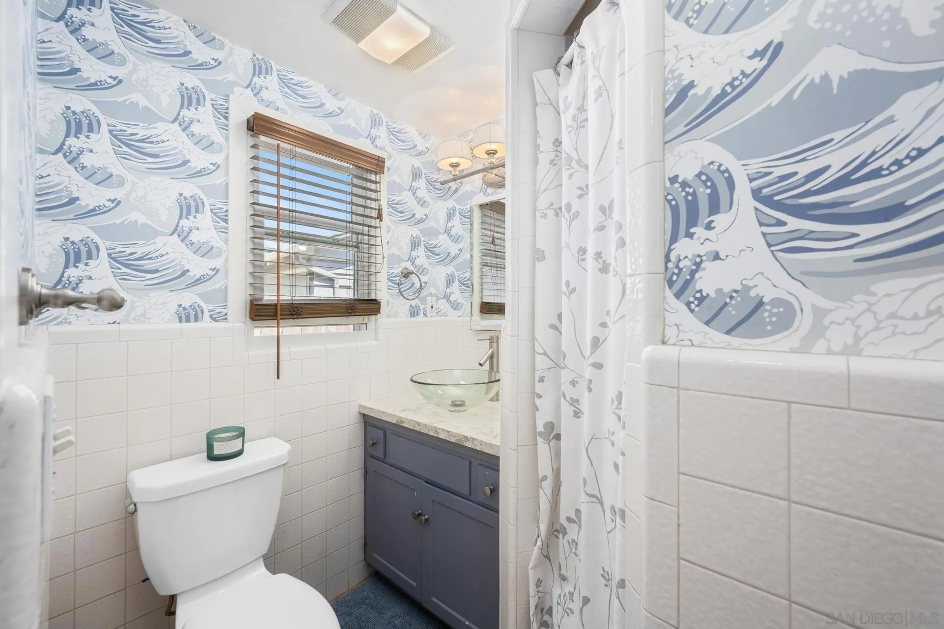 3733 La Cresta Drive San Diego, CA 92107 - Photo 31 of 57 a bathroom with a toilet sink and mirror