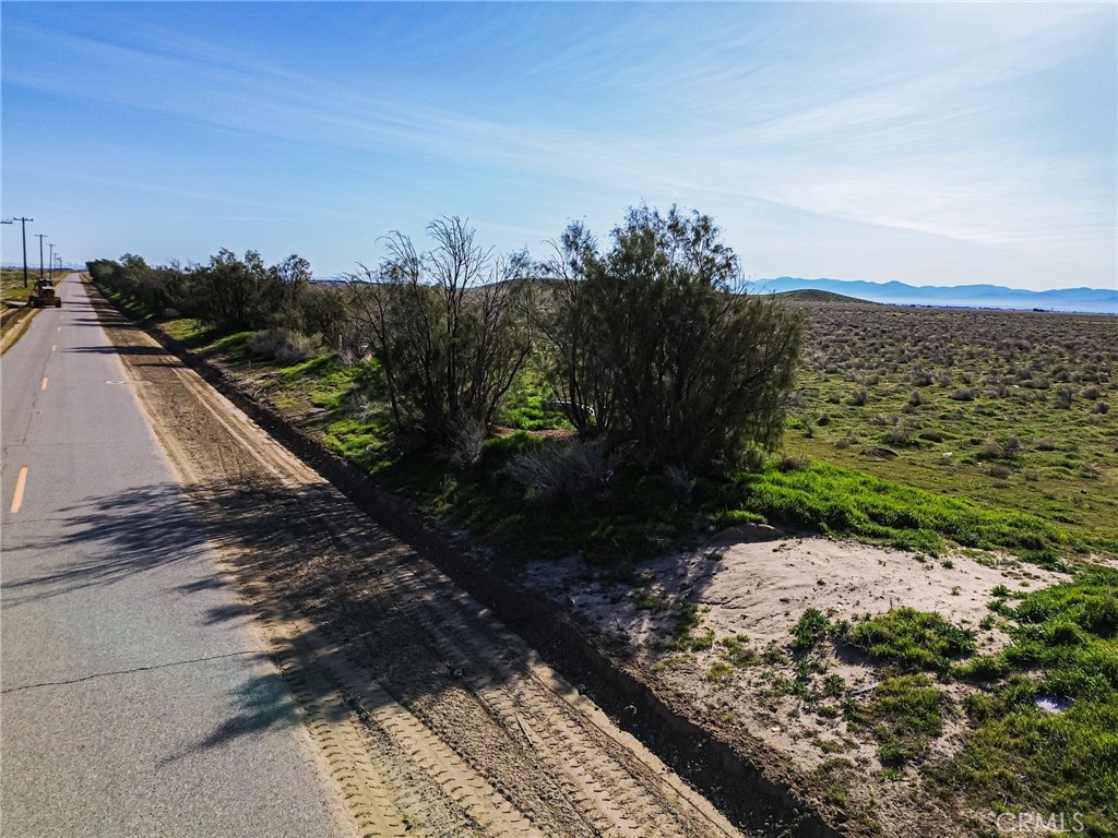 10400 West Ave B Lancaster, CA 93536 - Photo 41 of 43 a view of a pathway both side of grassy field with trees