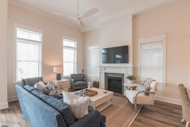a living room with furniture fireplace and window