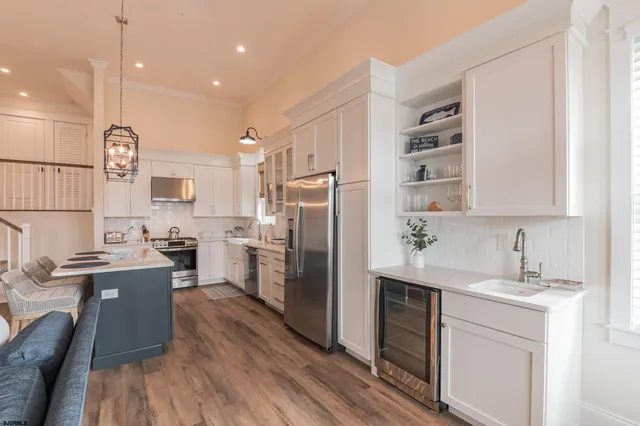 a kitchen with refrigerator cabinets and wooden floor