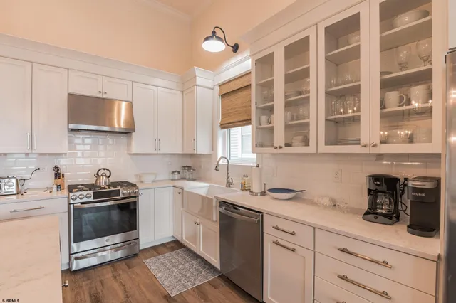 a kitchen with a sink stove and microwave
