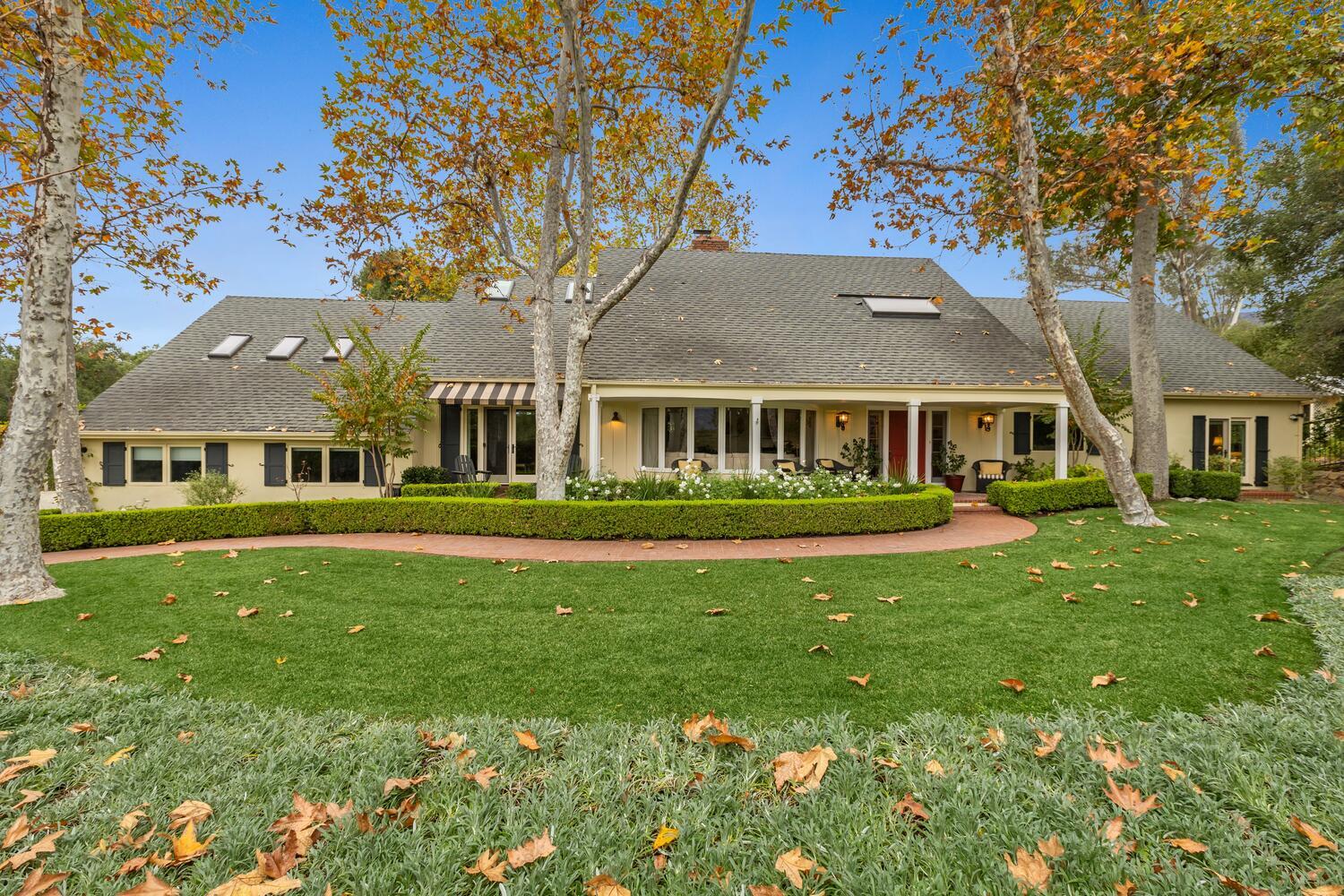 a front view of a house with a garden