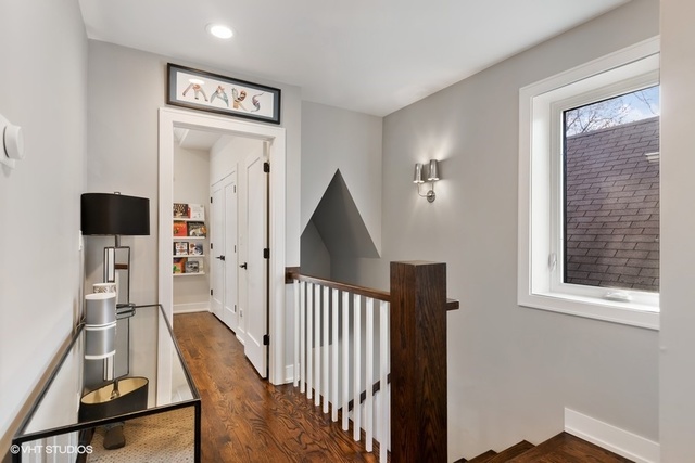 2708 West Nelson Street Chicago, IL 60618 - Photo 17 of 26 a view of a hallway with workspace and wooden floor