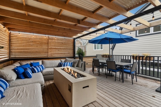 2708 West Nelson Street Chicago, IL 60618 - Photo 24 of 26 a view of a patio with couches and table and chairs under an umbrella