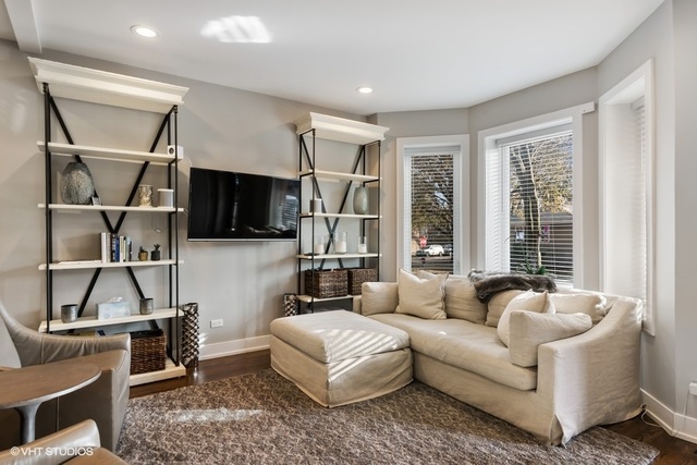 2708 West Nelson Street Chicago, IL 60618 - Photo 4 of 26 a living room with furniture a flat screen tv and a window