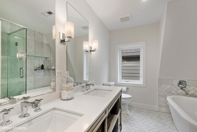 2708 West Nelson Street Chicago, IL 60618 - Photo 10 of 26 a bathroom with a sink double vanity granite tub shower and a mirror