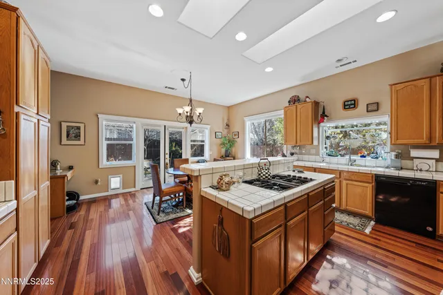 a kitchen with stainless steel appliances granite countertop a refrigerator stove and sink