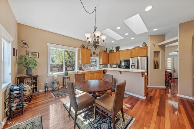 a kitchen with granite countertop a sink a counter top space stainless steel appliances and cabinets