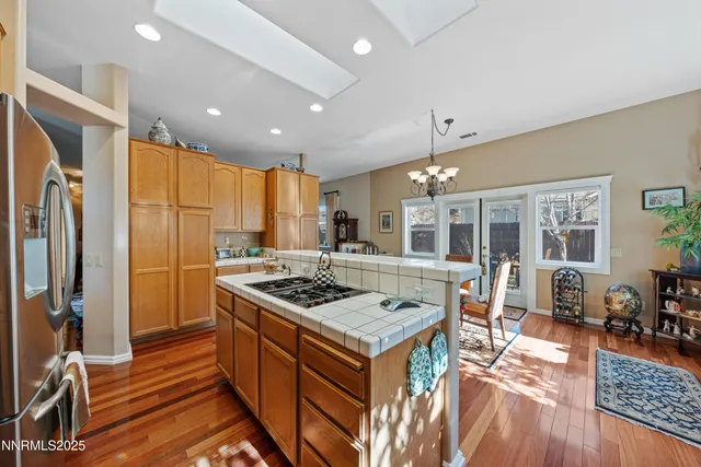 a bedroom with a bed a large window and flat screen tv