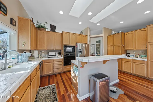 a en suite bathroom with a double vanity sink a mirror and a bathtub