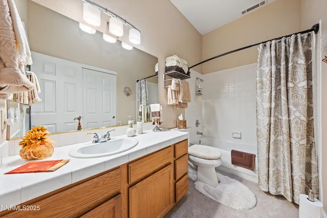 a spacious bathroom with a double vanity sink a mirror and a bathtub