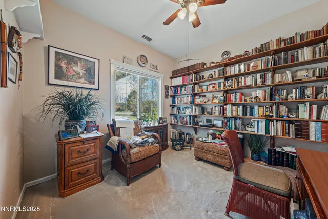a view of backyard with seating space and wooden fence
