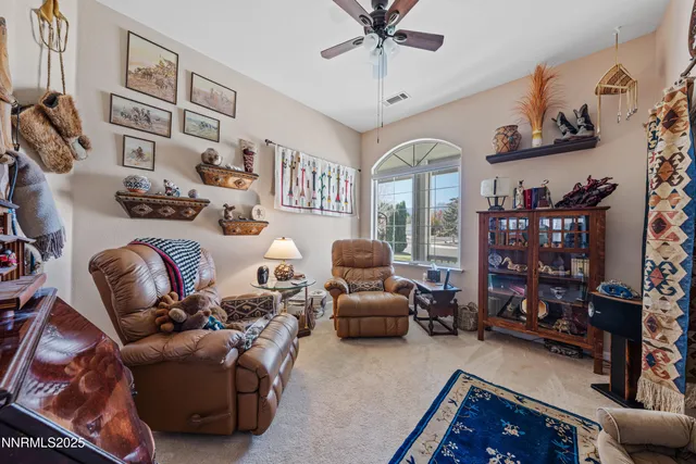 a view of a patio with a dining table and chairs with the ocean view