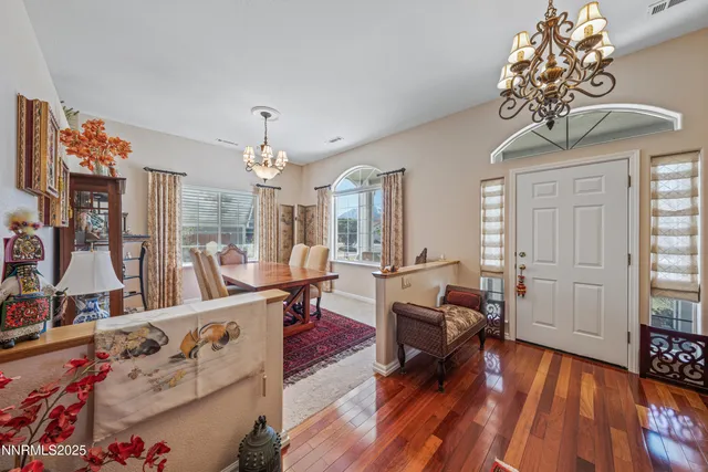 a living room with furniture and a chandelier
