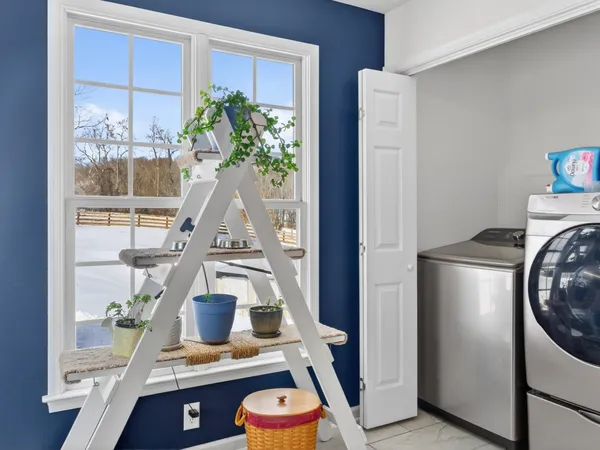 a view of living room with furniture and a potted plant