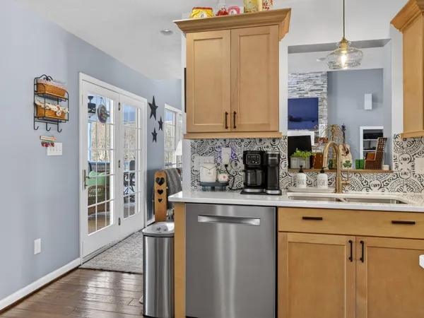 a kitchen with stainless steel appliances granite countertop a sink and a refrigerator