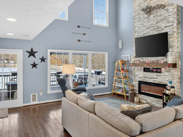 a living room with fireplace furniture and a flat screen tv