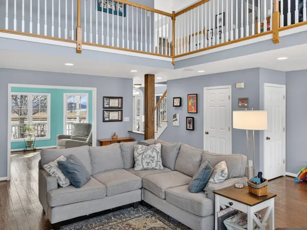 a living room with furniture a window and a flat screen tv