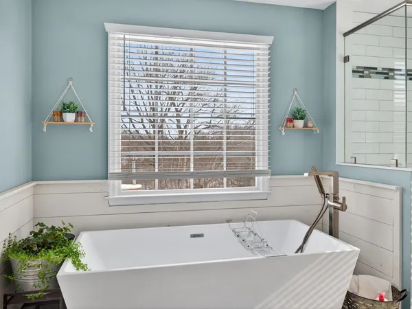 a bath tub sitting next to a window
