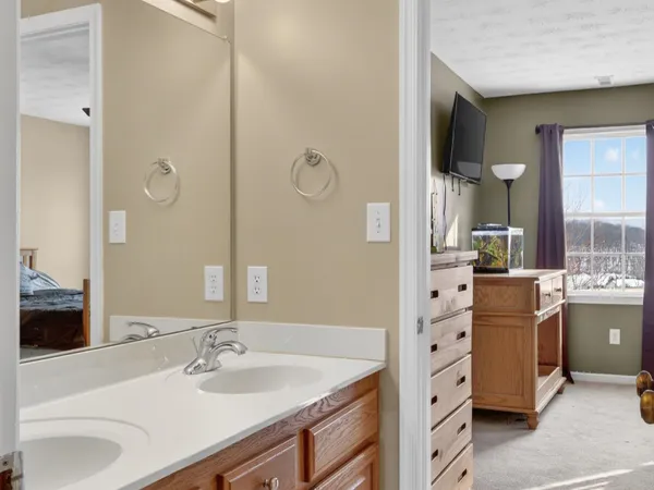 a bathroom with a granite countertop sink a mirror and a bathtub