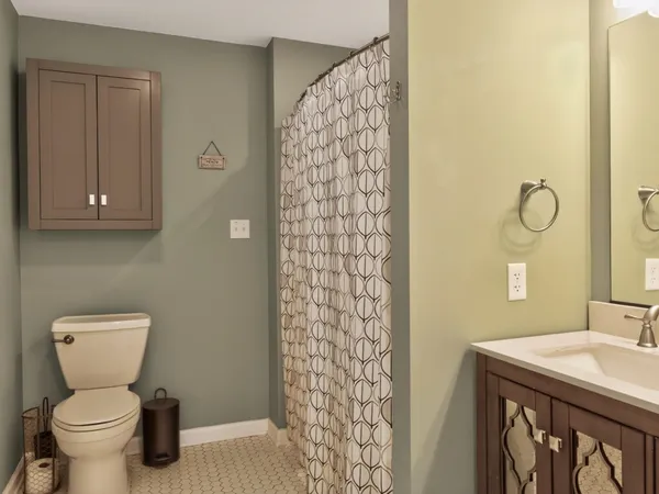 a bathroom with a sink toilet and shower