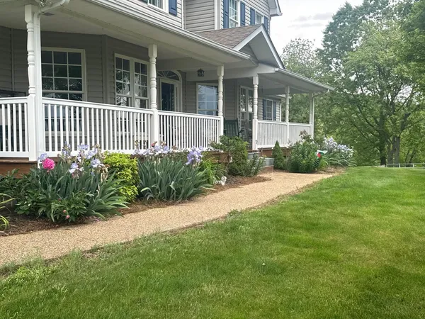 a view of a house with a yard and plants