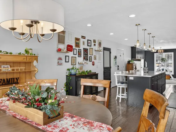 a living room with furniture fireplace and kitchen view