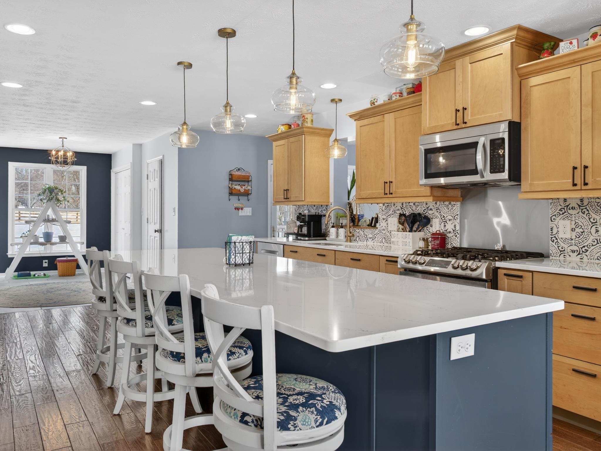 235 Howardsville Road Staunton, VA 24401 - Photo 10 of 51 a kitchen with stainless steel appliances granite countertop a stove a sink a microwave a dining table and chairs with wooden floor