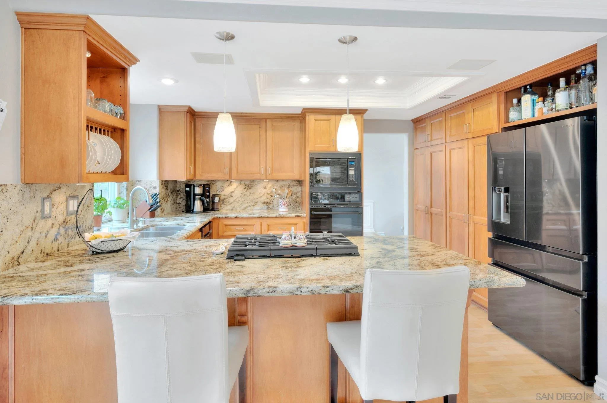 15095 Garden Road Poway, CA 92064 - Photo 11 of 55 a kitchen with kitchen island granite countertop a sink and cabinets