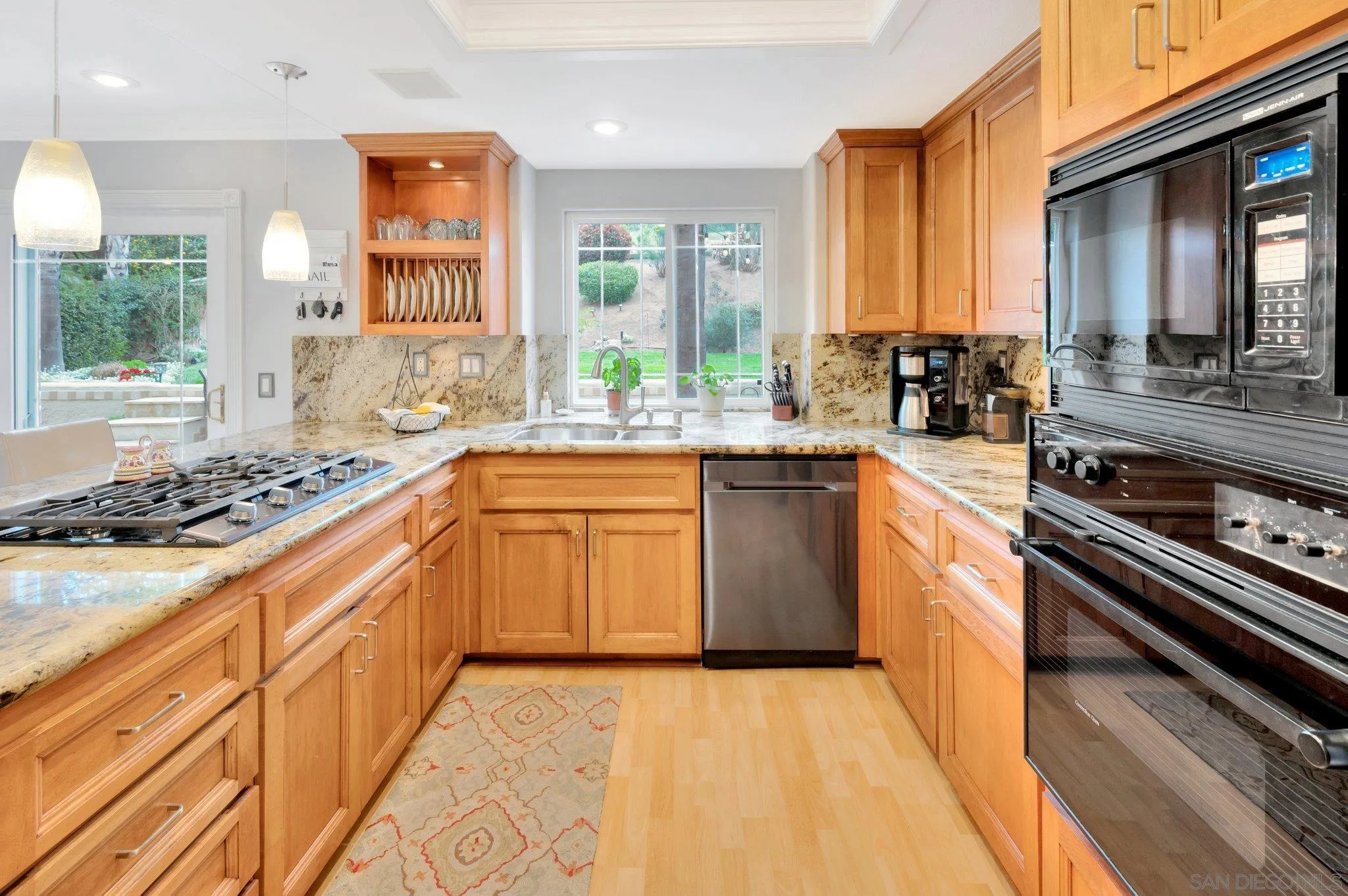 15095 Garden Road Poway, CA 92064 - Photo 12 of 55 a kitchen with a sink stove and cabinets