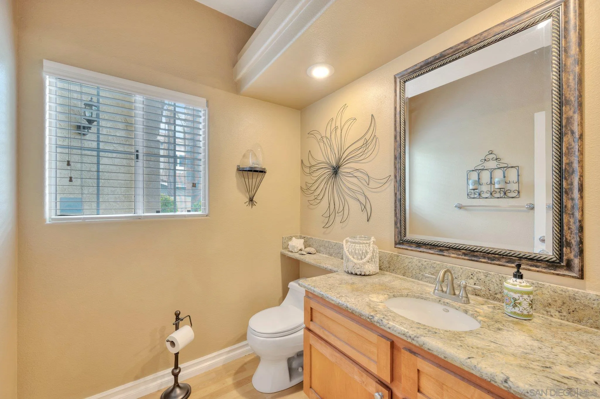 15095 Garden Road Poway, CA 92064 - Photo 19 of 55 a bathroom with a granite countertop toilet a sink and a mirror