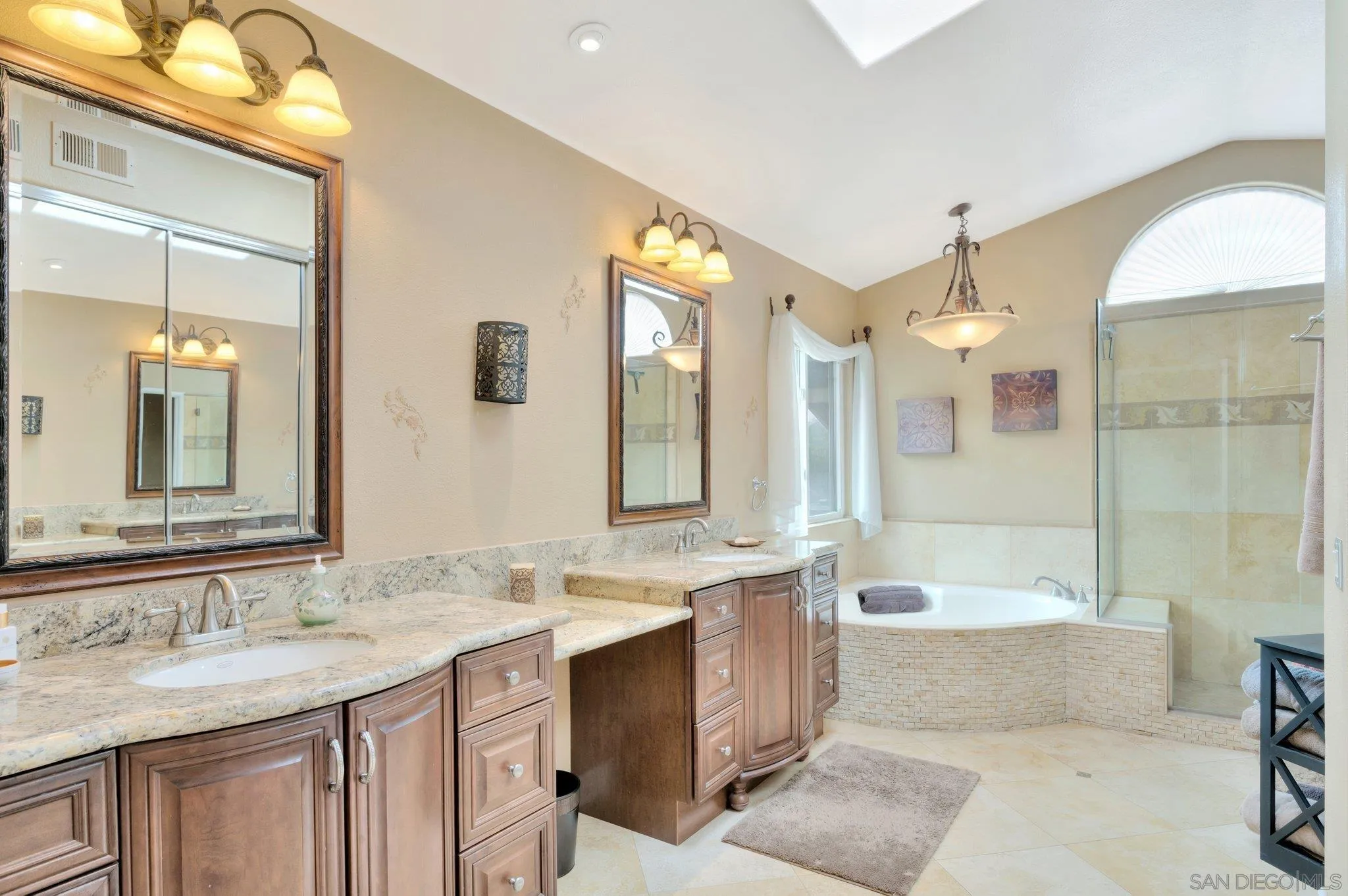 15095 Garden Road Poway, CA 92064 - Photo 25 of 55 a bathroom with a granite countertop tub sink and mirror