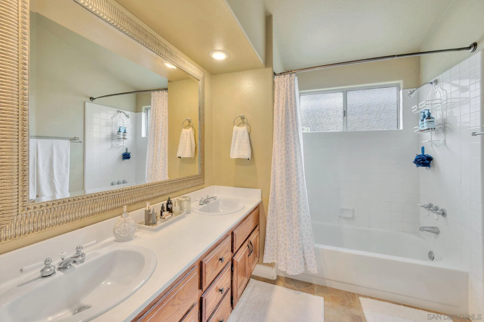 15095 Garden Road Poway, CA 92064 - Photo 28 of 55 a bathroom with a tub sink and mirror
