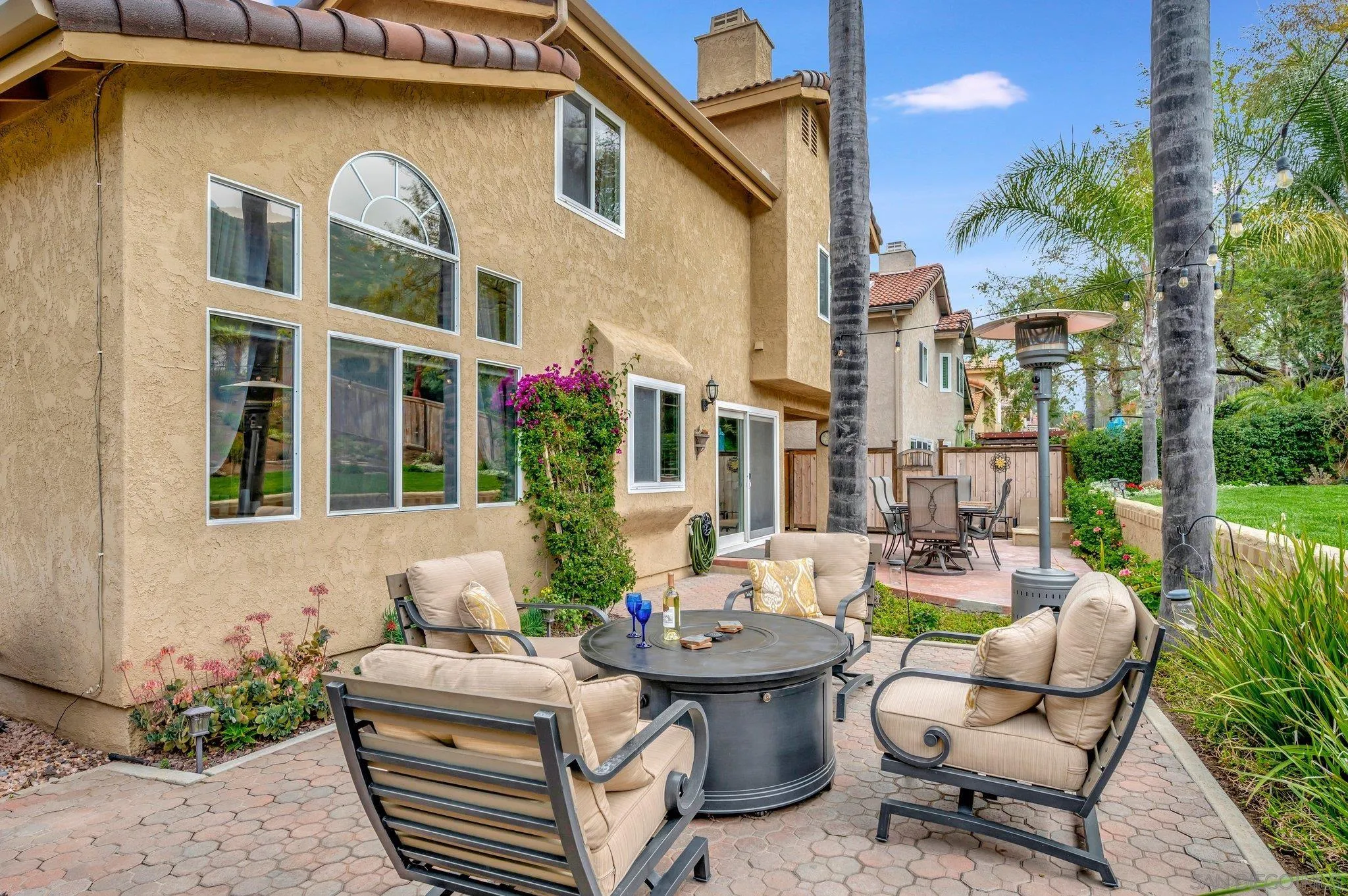 15095 Garden Road Poway, CA 92064 - Photo 38 of 55 a view of a patio with couches table and chairs and potted plants