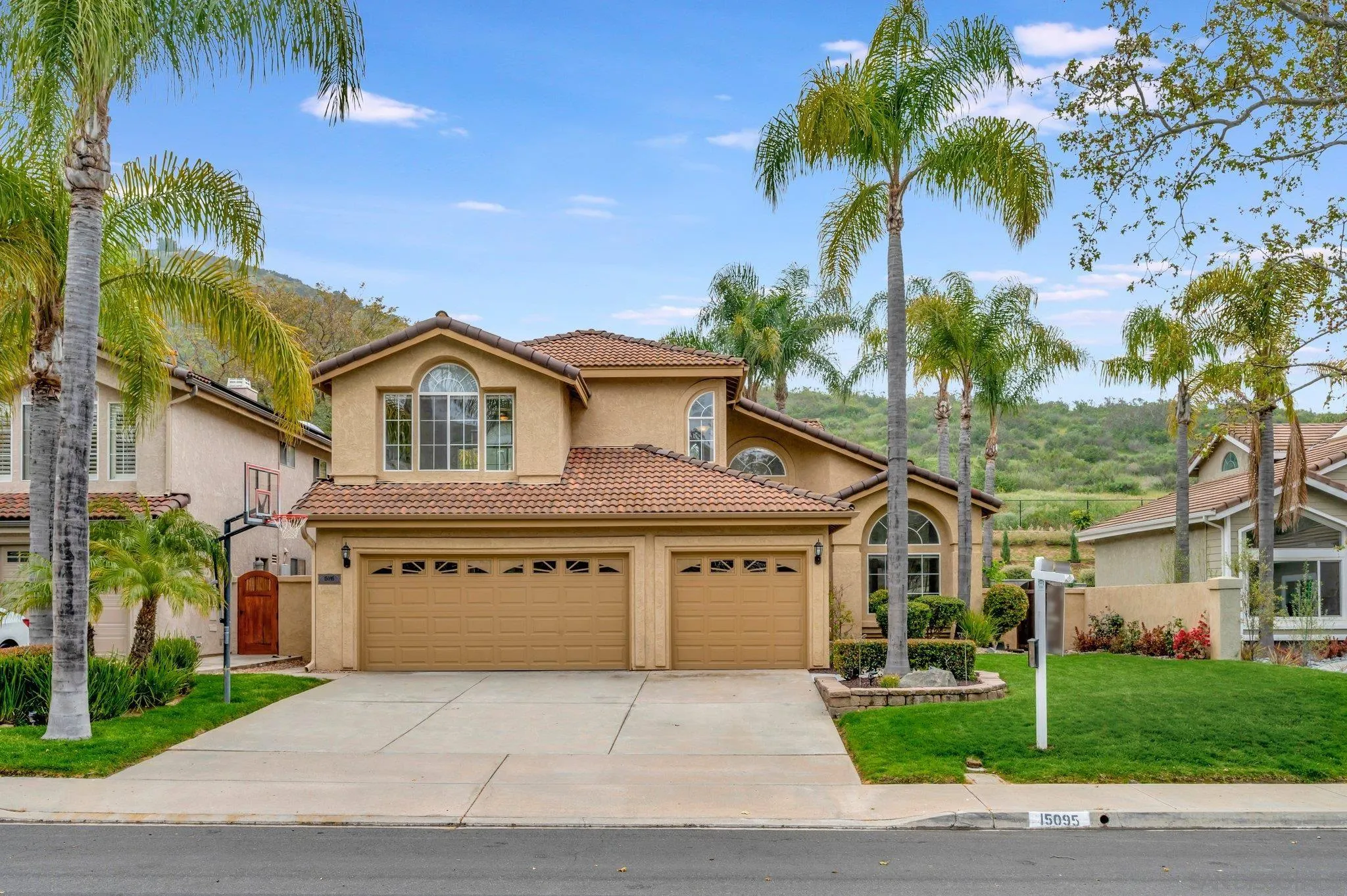 15095 Garden Road Poway, CA 92064 - Photo 4 of 55 a front view of a house with a garden and entryway