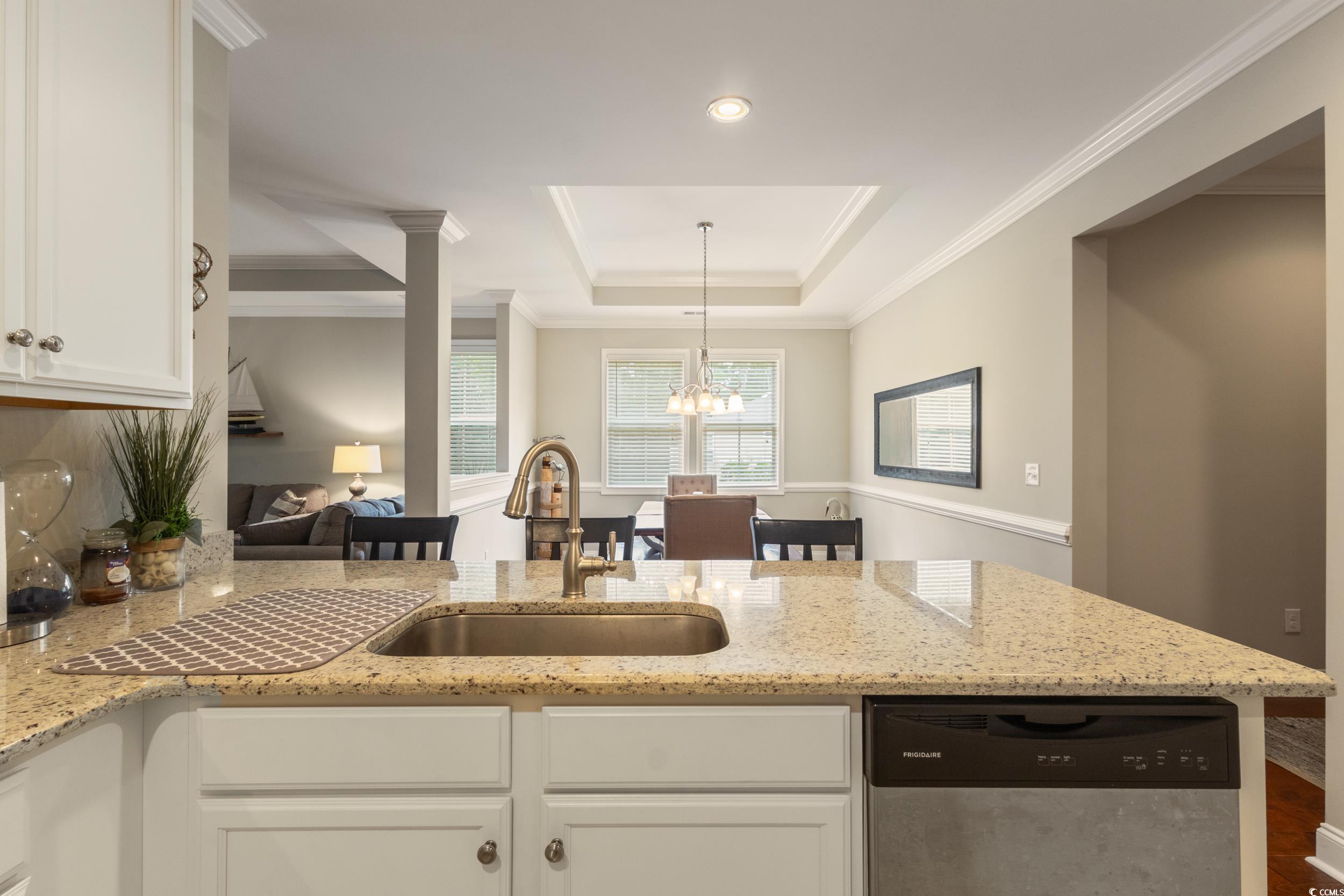 482 Botany Loop, Unit 155 Murrells Inlet, SC 29576 - Photo 14 of 40 Kitchen with stainless steel dishwasher, a tray ceiling, a peninsula, white cabinetry, and light stone counters