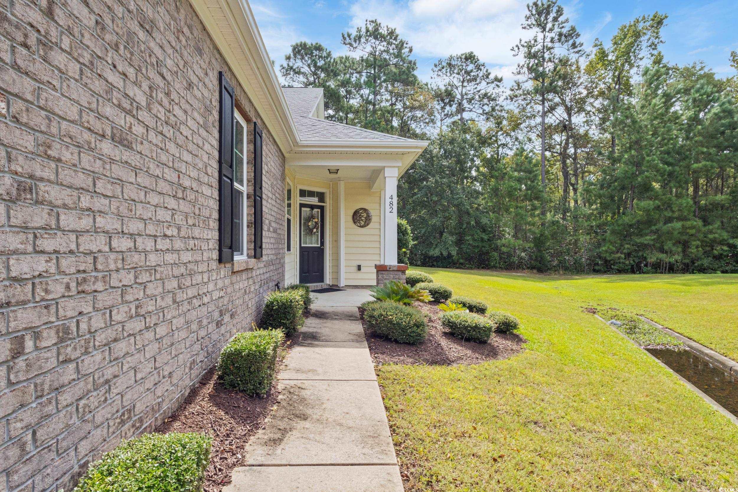 482 Botany Loop, Unit 155 Murrells Inlet, SC 29576 - Photo 3 of 40 Entrance to property with a yard and roof with shingles