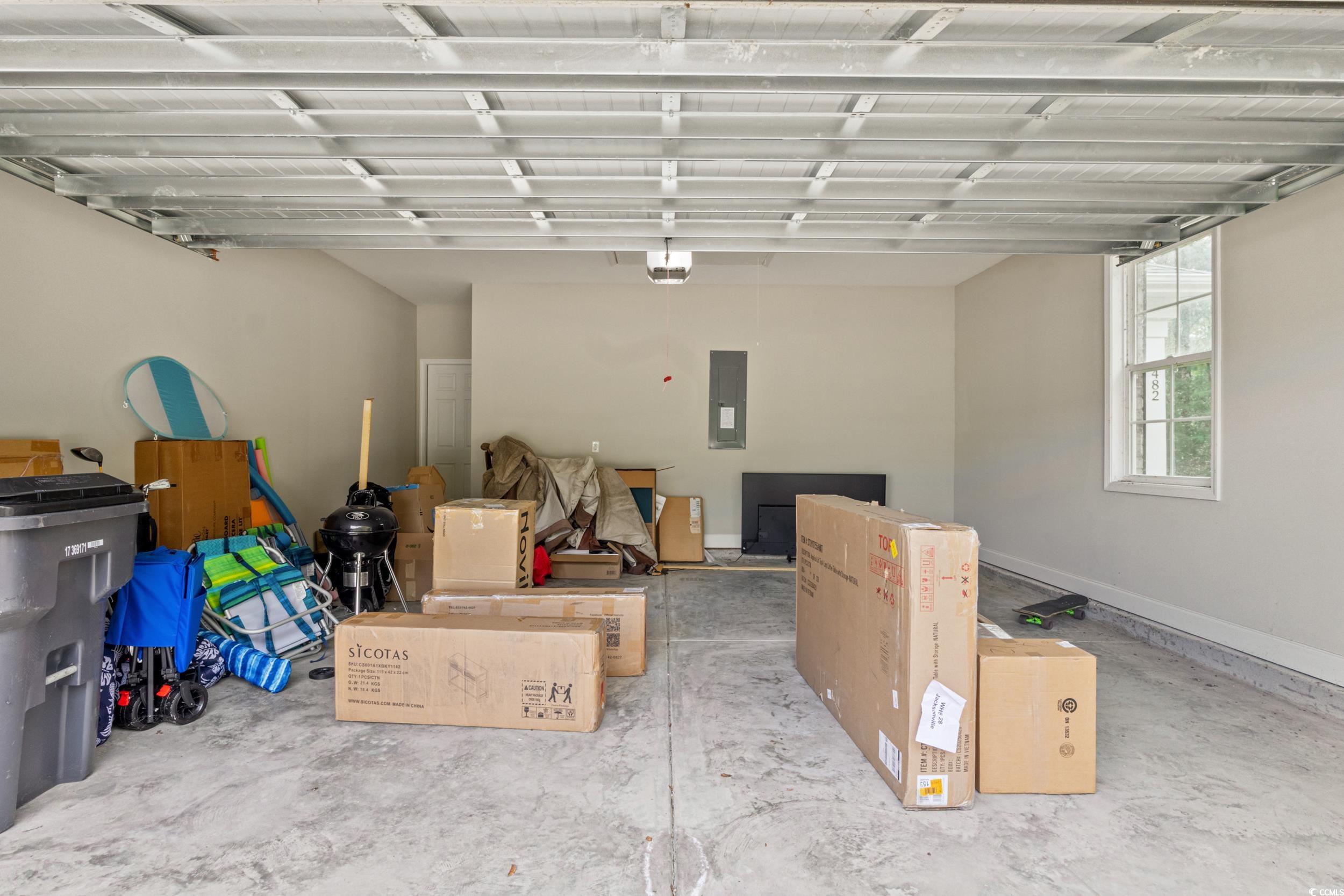 482 Botany Loop, Unit 155 Murrells Inlet, SC 29576 - Photo 31 of 40 Garage with electric panel and a garage door opener