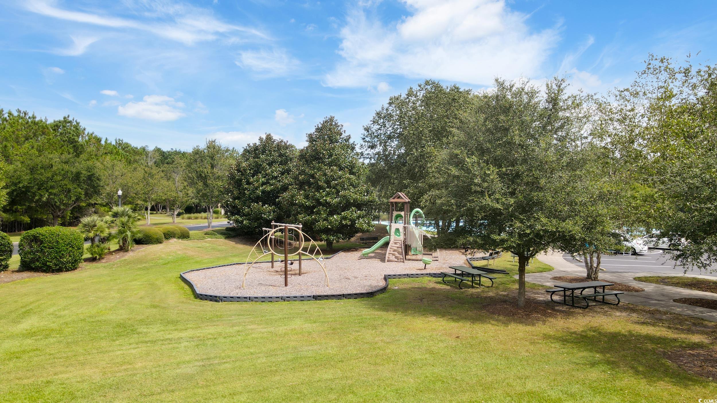 482 Botany Loop, Unit 155 Murrells Inlet, SC 29576 - Photo 35 of 40 Communal playground featuring a yard, view of scattered trees, and a patio