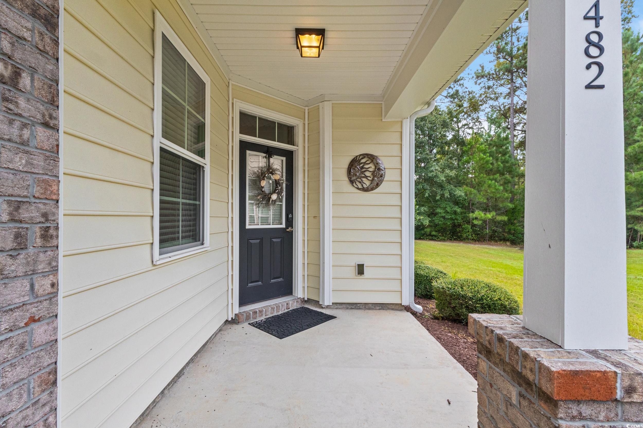 482 Botany Loop, Unit 155 Murrells Inlet, SC 29576 - Photo 4 of 40 Doorway to property featuring a porch and a yard