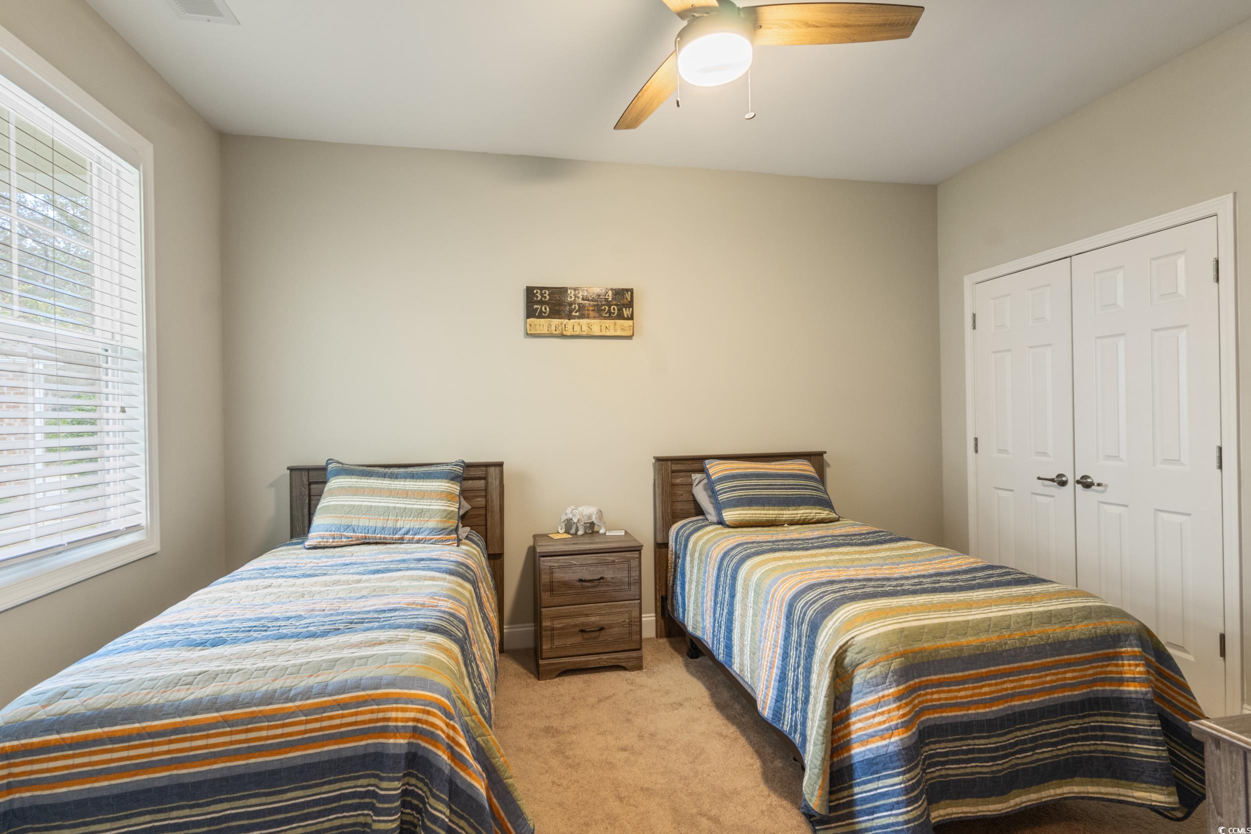 482 Botany Loop, Unit 155 Murrells Inlet, SC 29576 - Photo 9 of 40 Bedroom with carpet floors, a closet, and a ceiling fan